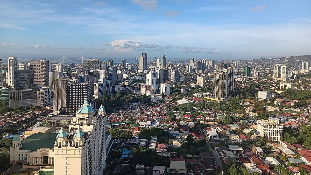 Cebu City skyline seen from Cebu IT Park with high-rise towers and a cable-stayed bridge on the horizon