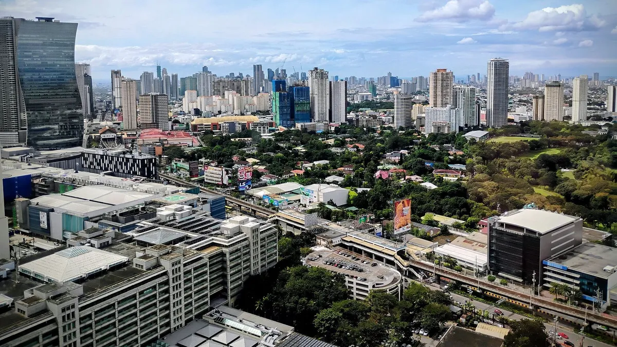 Ortigas Center skyline in Metro Manila with completed condo towers and a new tower under construction